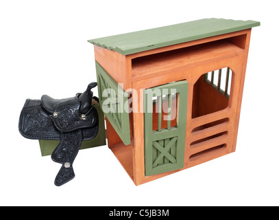 Saddle hanging on a Dutch door of a wooden shed - path included Stock Photo