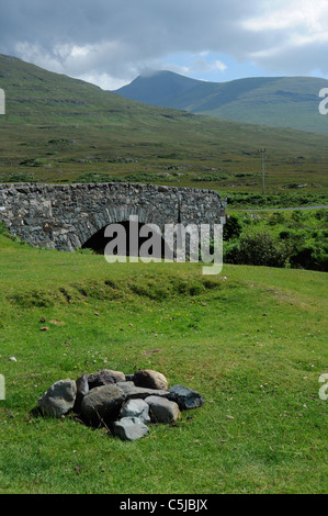 Stones of old camp fire and road bridge over river on the south bank of Loch na Keal, Isle of Mull, Argyll, Scotland, UK Stock Photo