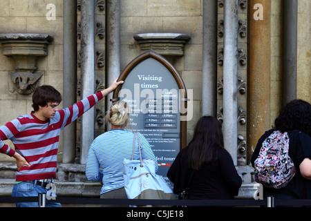 Tourists waiting to enter Westminster Abbey via the Great North Door, London England Stock Photo