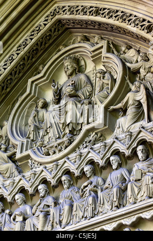 Detail of stone carvings of Jesus, angels and disciples on tympanum of Great North Door, Westminster Abbey, London, England Stock Photo