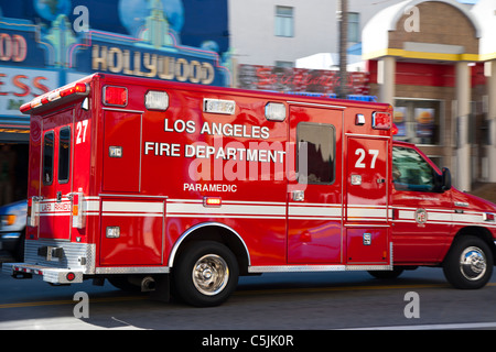 Emergency ambulance racing past in Hollywood, Los Angeles, California, USA Stock Photo