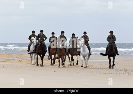 The Queen's platoon of the Household Cavalry exercising their horses on Holkham beach -Norfolk Stock Photo