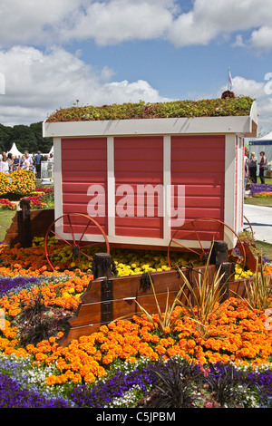 Red white wooden painted seaside style Garden shed. Life beach House Landscape Garden Exhibit RHS Royal Horticultural Show Tatton Park, Cheshire, July 2011. Stock Photo