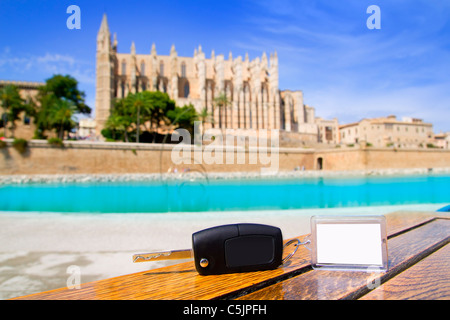 Car rental keys on wood table with blank paper in Palma de Mallorca cathedral Stock Photo