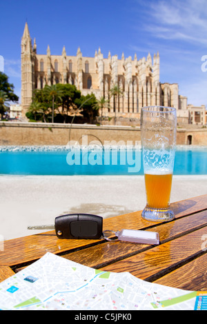 Car rental keys on wood table with city tourist map in Palma de Mallorca cathedral Stock Photo
