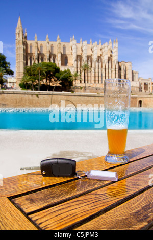 Car rental keys on wood table with blank paper in Palma de Mallorca cathedral Stock Photo