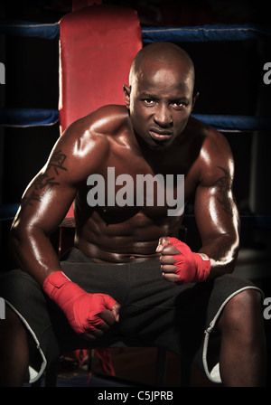 Portrait of male black boxer in the ring Stock Photo