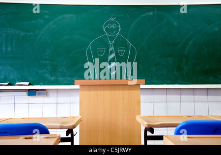 draw teacher on the blackboard in the classroom of school Stock Photo