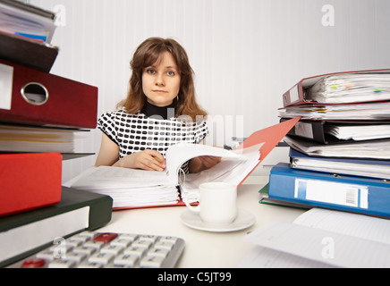 Female accountant very busy working in the office Stock Photo