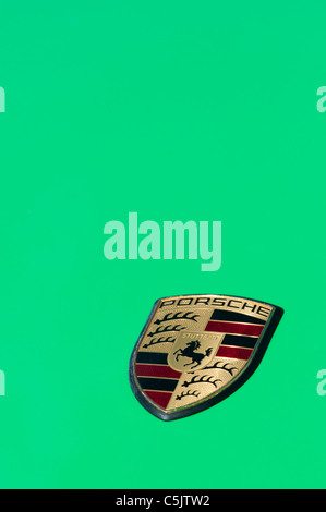 Porsche car badge on green Stock Photo