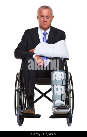 Photo of an injured businessman sitting in a wheelchair, isolated against a white background. Stock Photo