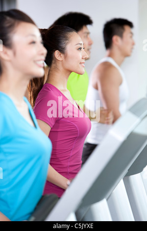 Four People Running on Treadmills Stock Photo