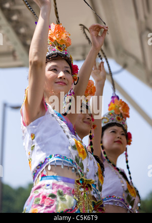 Traditional Chinese folk dancers perform on stage Stock Photo