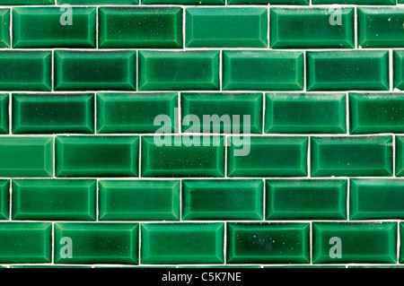 Closeup of a wall covered with green decorative tiles Stock Photo