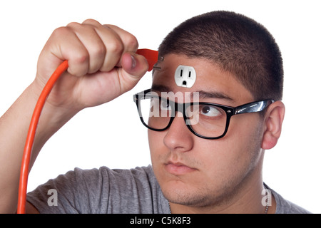 Conceptual image of a young man holding an electrical chord unplugged from the outlet on his forehead. Stock Photo