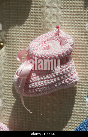 woollen baby bootees in shop window Stock Photo