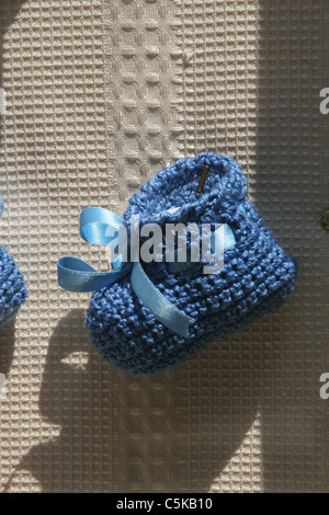 woollen baby bootees in shop window Stock Photo