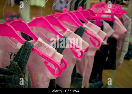 https://l450v.alamy.com/450v/c5khw4/clothes-hang-on-hangers-in-shop-kids-pink-hangers-c5khw4.jpg