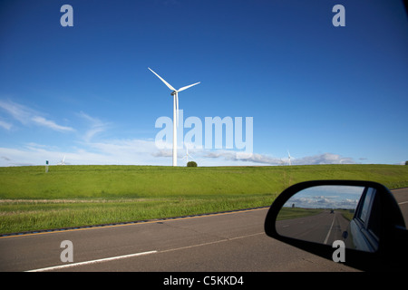 driving past wind turbine on windmill wind farm near minot north dakota USA Stock Photo