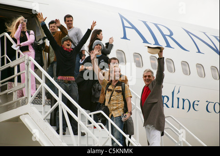 Stars of Lord of the Rings movies waving farewell on steps of Air New Zealand Boeing 767 airliner at Wellington Airport, New Stock Photo