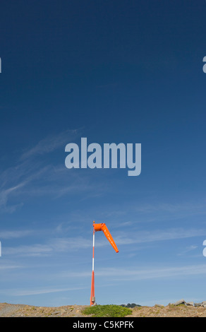 Orange windsock against blue sky with white cirrus clouds, Wellington Airport Stock Photo