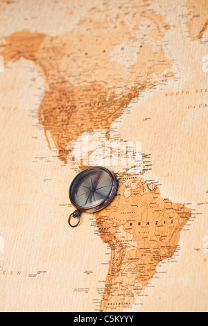 World map with compass showing North and South America Stock Photo