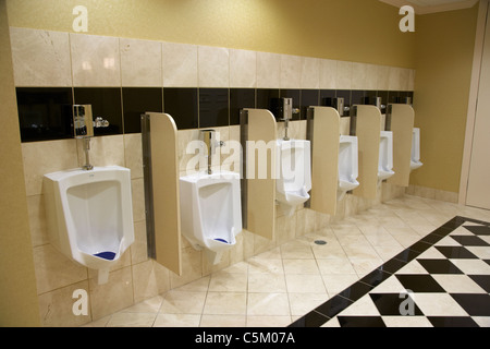 row of urinals in a hotel toilet in Nashville Tennessee USA Stock Photo