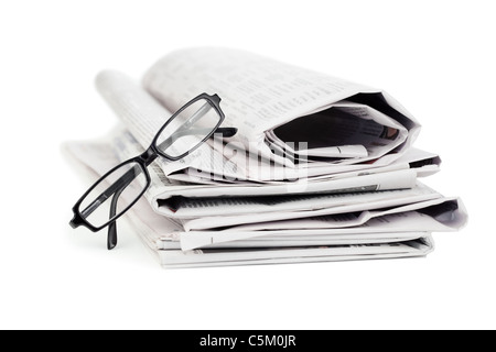A pile of newspapers and a pair of reading glasses