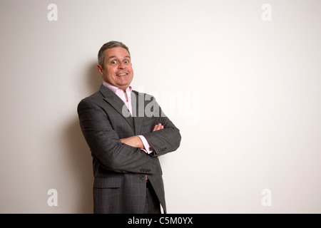 Businessman with folded arms smiling Stock Photo