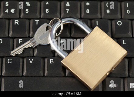 Padlock and key on a keyboard Stock Photo
