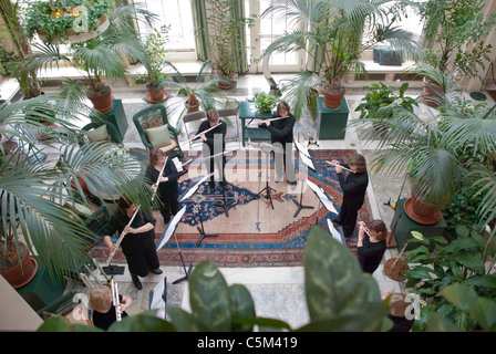 A flute choir in the conservatory of the George Eastman House entertains museum-goers in Rochester, New York. Stock Photo
