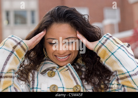 This woman is experiencing an intense amount of stress or possibly a headache. Stock Photo