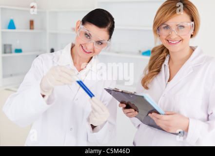 Two scientists looking at the camera while working in a lab Stock Photo