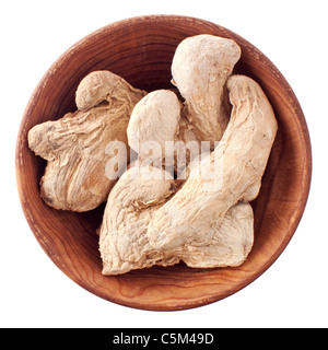 Dry ginger root in a wooden bowl isolated on white background Stock Photo