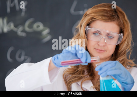Young female scientist carrying out an experiment