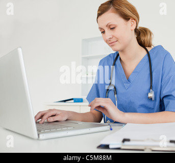 Young female doctor working on her laptop Stock Photo