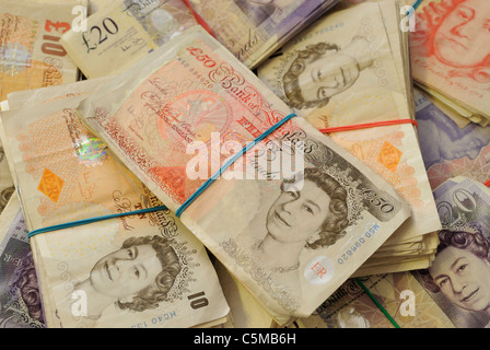 A close-up photo of large numbers of used British high-value banknotes. Stock Photo