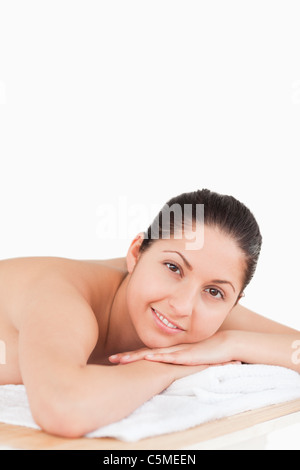 Dark-haired young woman on a table Stock Photo
