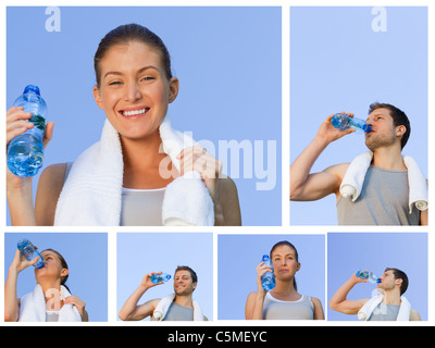Young couple resting and drinking some water after jogging Stock Photo