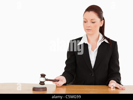 Young judge knocking a gavel Stock Photo