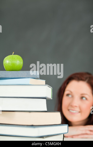 Little schoolgirl with stack of books Stock Photo - Alamy