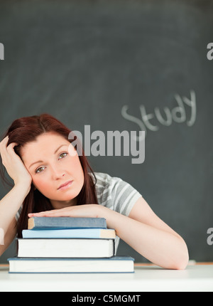 Potrait of a tired young woman studying Stock Photo