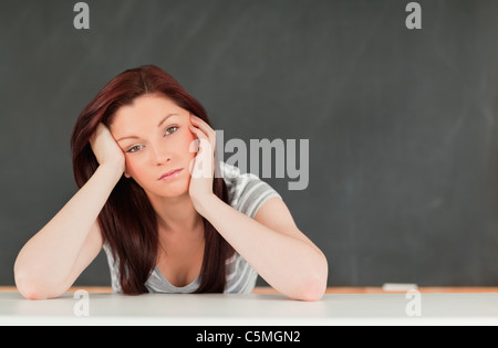 Tired student in a classroom Stock Photo