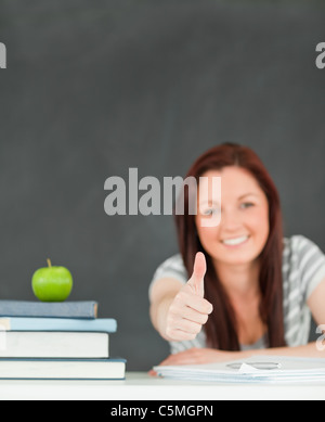 Little schoolgirl with apple in classroom Stock Photo - Alamy