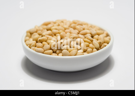 pine nuts in a white bowl Stock Photo