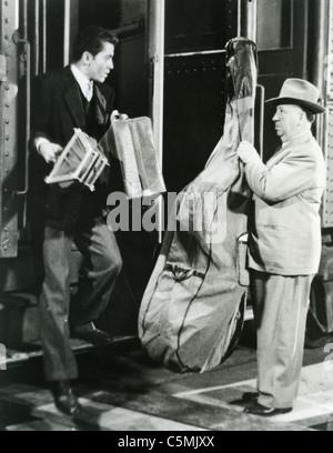 STRANGERS ON A TRAIN 1951 Warner Bros film with Farley Granger and Alfred Hitchcock with double bass in a cameo appearance Stock Photo