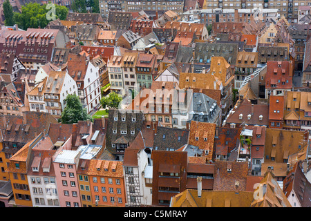 vivid old house roofs covered with traditional red and orange tiles in Strasbourg city Stock Photo