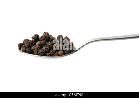 Black pepper on a teaspoon isolated on white background Stock Photo