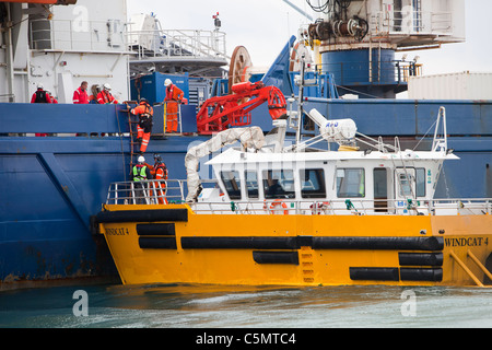 Offshore workers transfering to a cable laying vessel on the Walney Offshore windfarm project, off Barrow in Furness,
