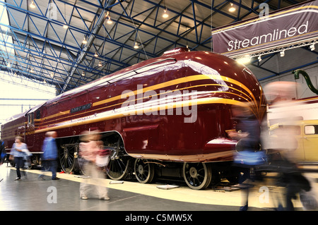 Steam locomotive No 6229 Duchess of Hamilton at  the National Railway Museum in York with visitors blurred as they move around. Stock Photo